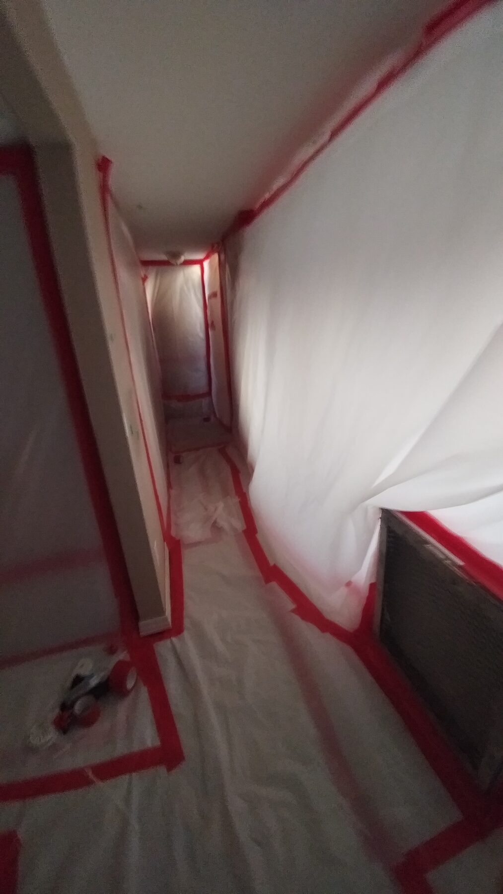 Taped and sealed containment corridor inside an occupied home