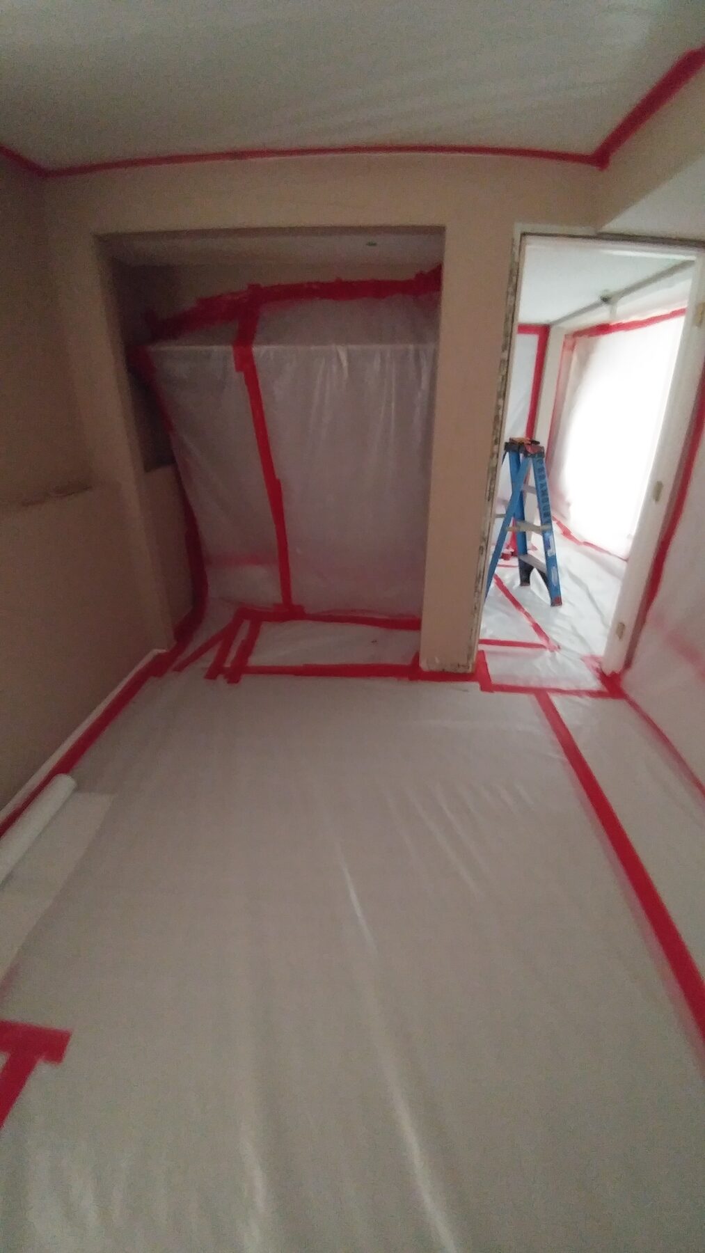 Bedroom closet containment with taped seams and protected flooring